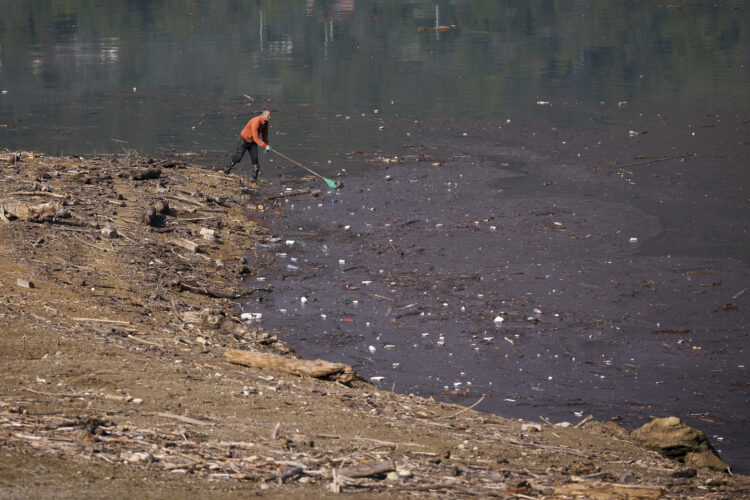 Residents and activists in central Bosnia clean up a lake after  massive floods